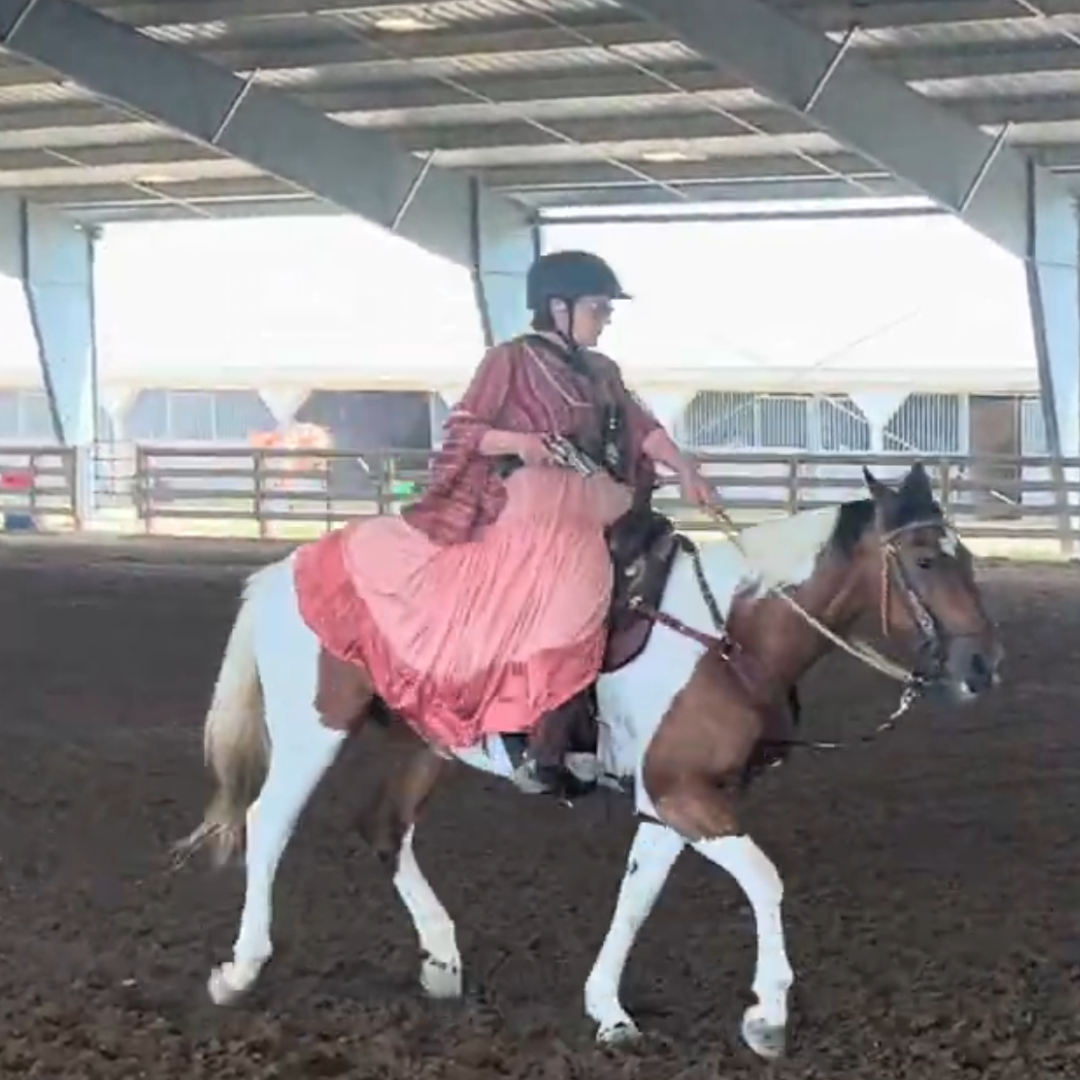 Criminal defense attorney Sallynda Rothchild of SRD Law Office practicing cowboy mounted shooting on horseback.