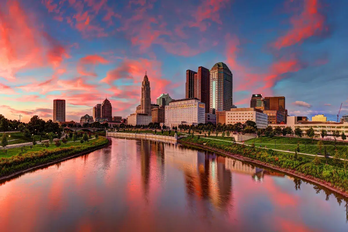 Downtown Columbus skyline reflected in the Scioto River at sunset